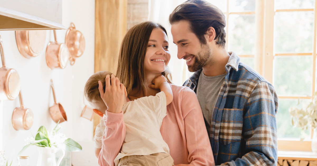 Happy family in kitchen with child